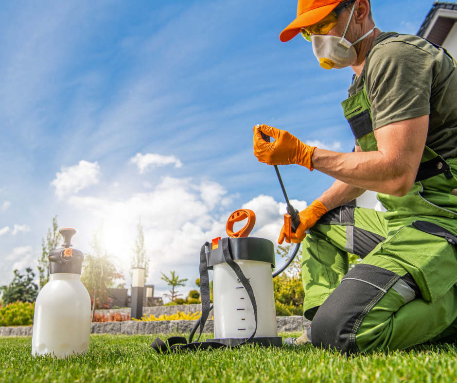 Licensed lawn care technician applying treatment with protective equipment