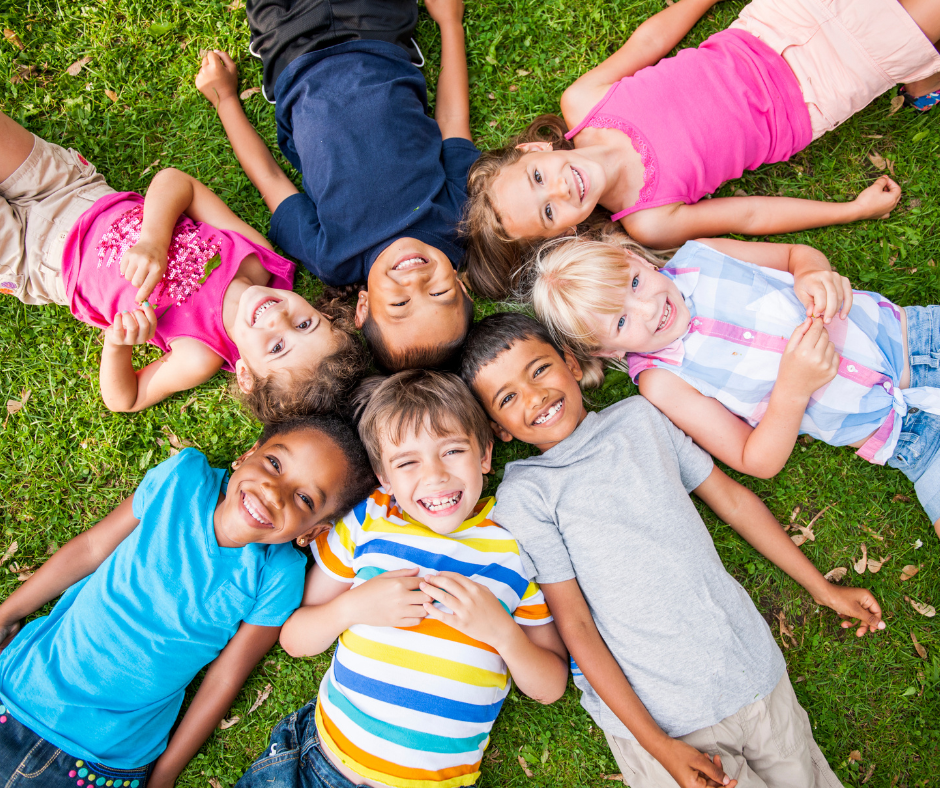 Kids relaxing on a healthy, safely treated lawn