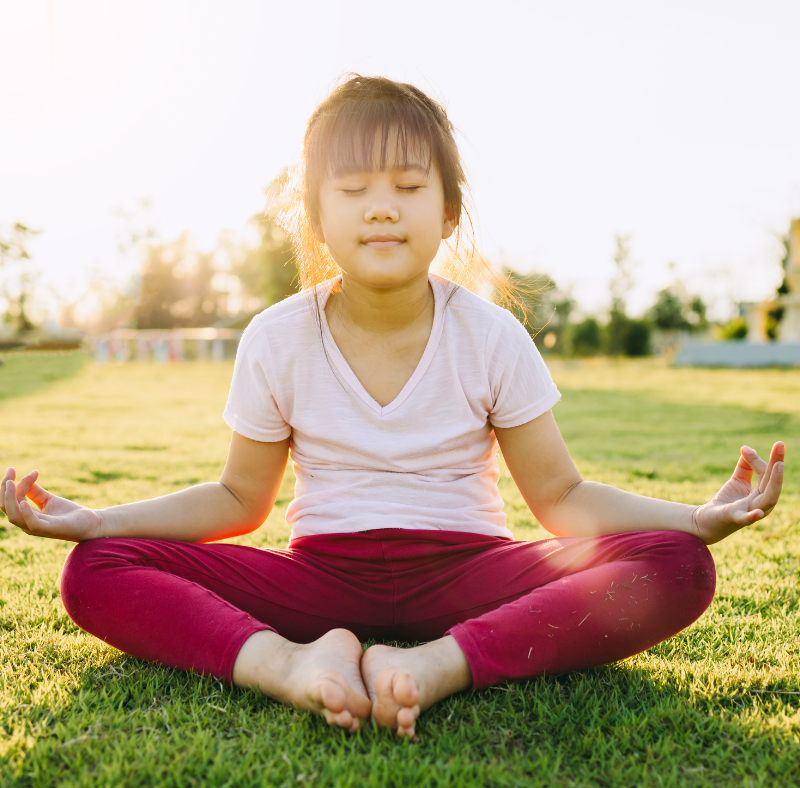 Child sitting comfortably on a treated lawn