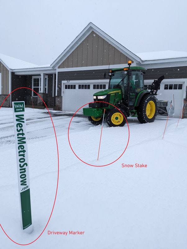 Plow clearing a driveway with a driveway marker and a snow stake labeled for comparison